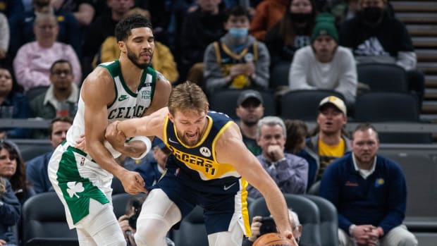Jan 12, 2022; Indianapolis, Indiana, USA; Boston Celtics forward Jayson Tatum (0) fouls Indiana Pacers forward Domantas Sabonis (11) in the first half at Gainbridge Fieldhouse. Mandatory Credit: Trevor Ruszkowski-USA TODAY Sports